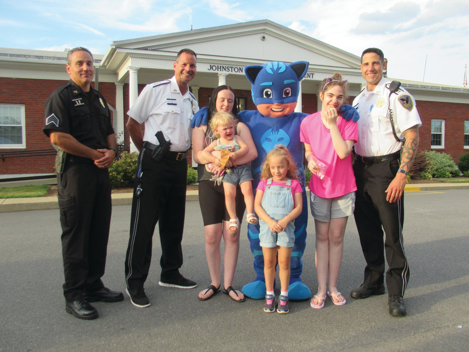 PIZZA PARTY PALS: JPD Chief Joseph P. Razza, Capt. Mike Babbitt and Sgt. Luca Lancellotti are all smiles while being joined by Charlotte Pinheiro, Avery Hedyka, Lydia Hedyka and Kayla Beaudry during last Wednesday’s super social event in Johnston.
